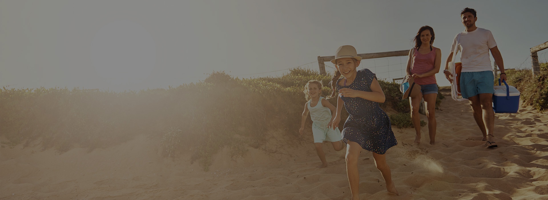 family running on the beach